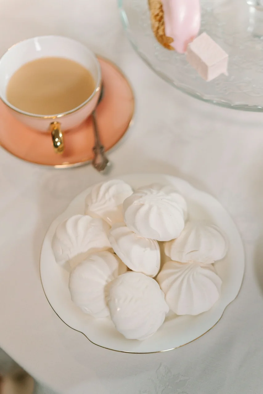 Delicate meringues and porcelain tea cup